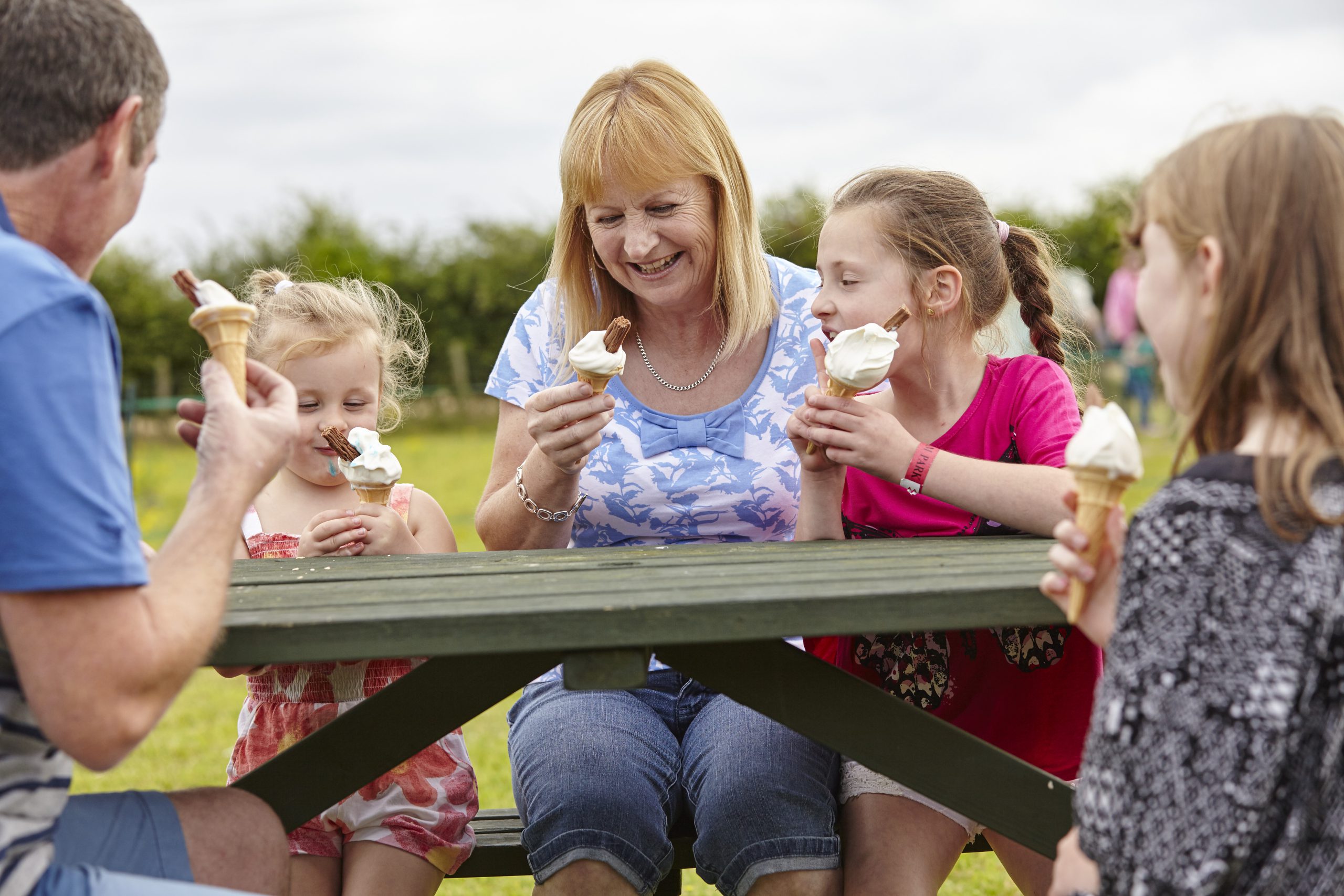 Family on bench together 01 - First4Adoption